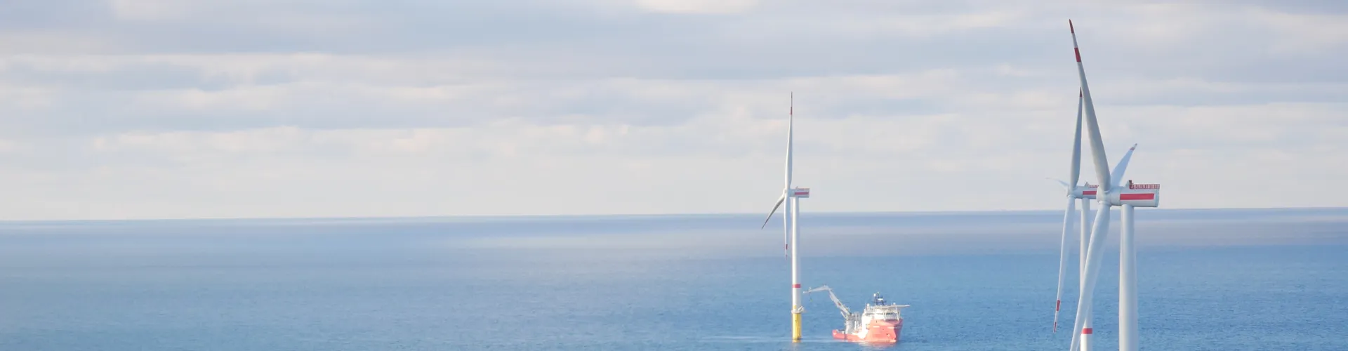 Ship near offshore wind turbine at sea