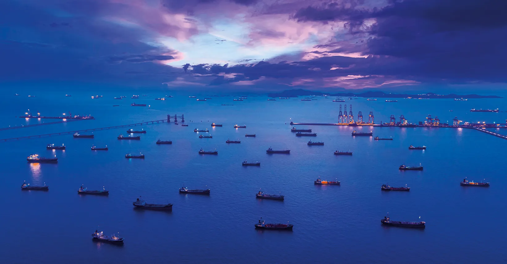 Aerial view of oil tankers at anchor at sea at dusk