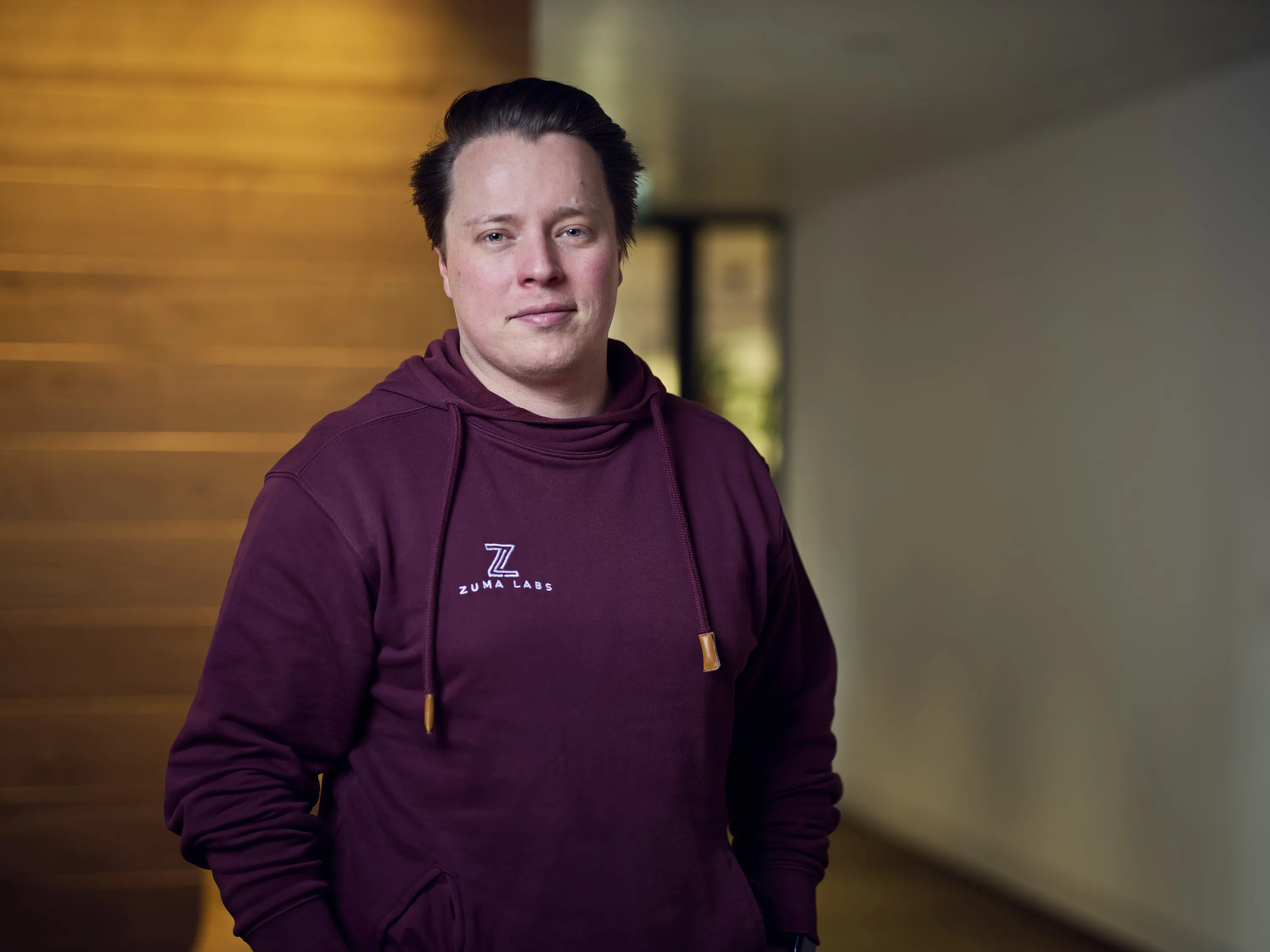 Person in maroon Zuma Labs hoodie