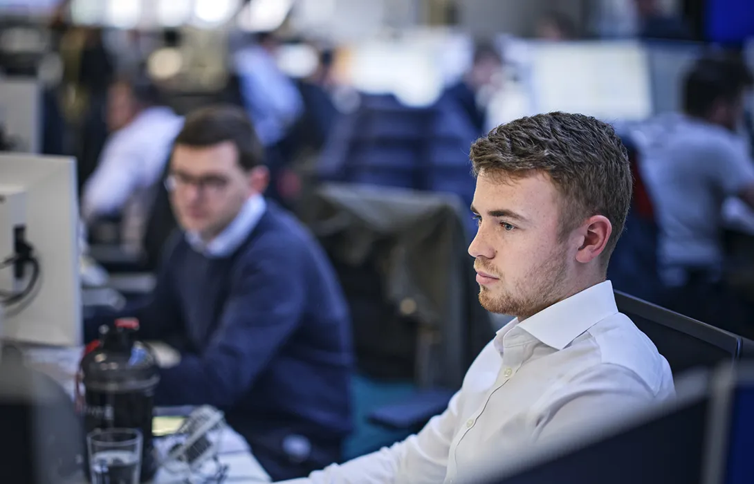 broker in the office at his computer
