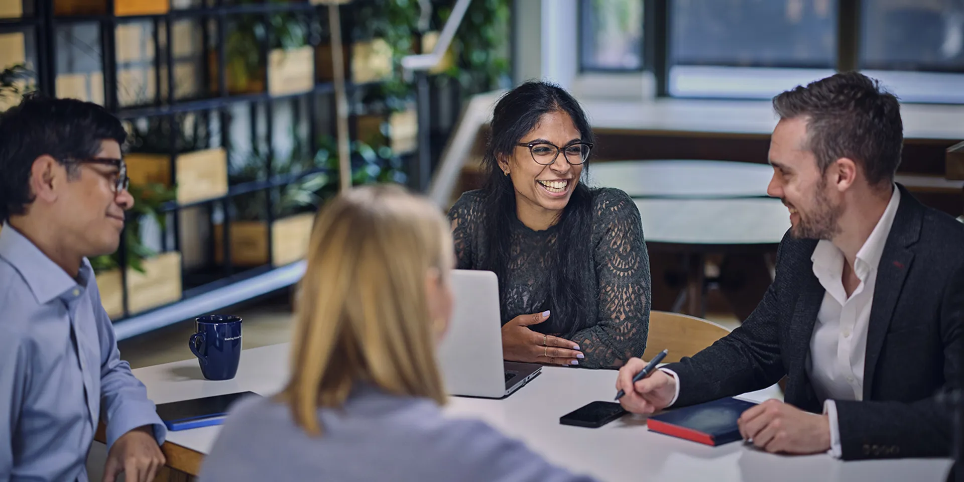 colleagues discussing work at a table