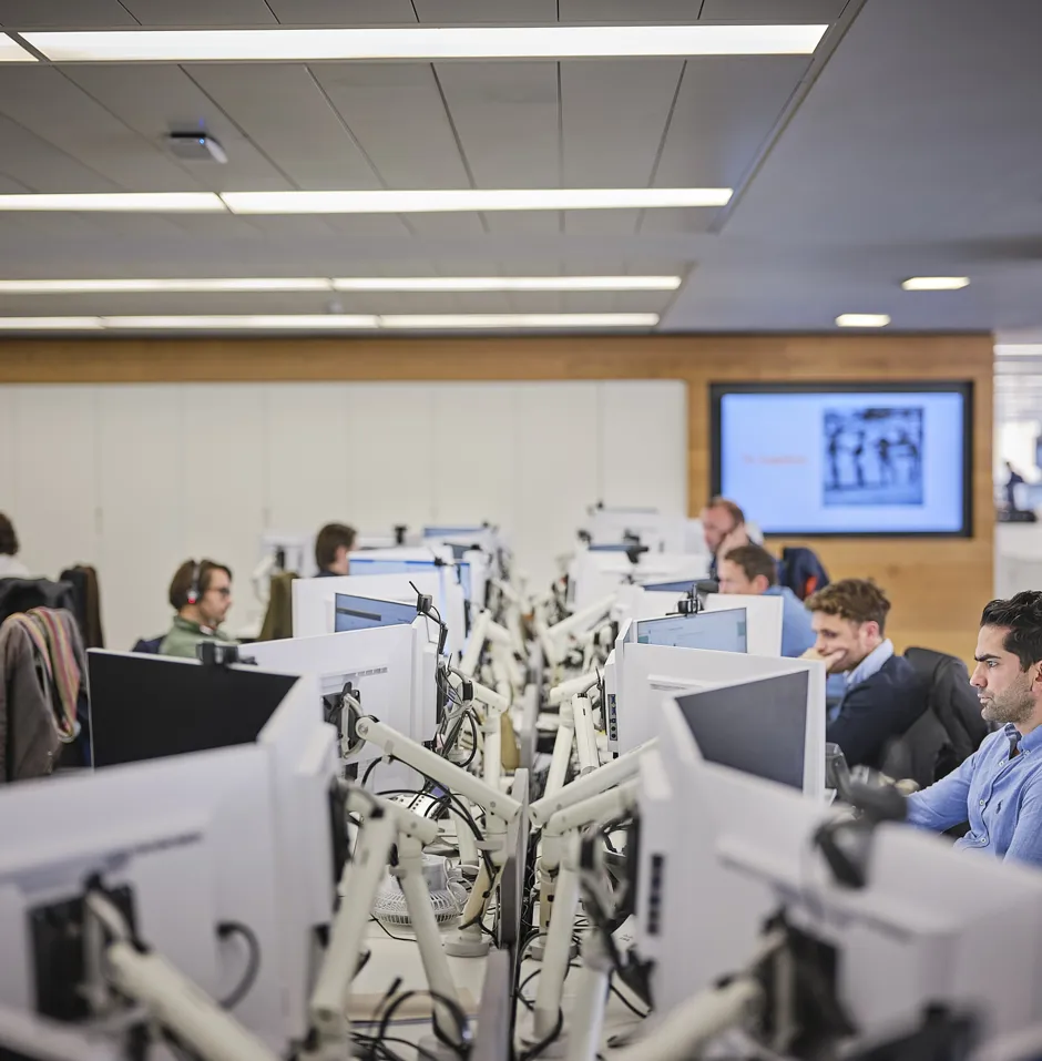 Office workspace with people at desktop computers.