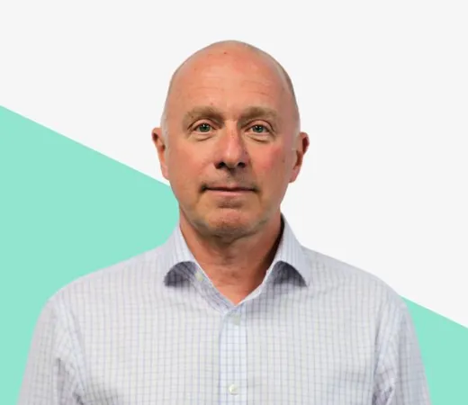 Bald man in blue checked shirt, white background