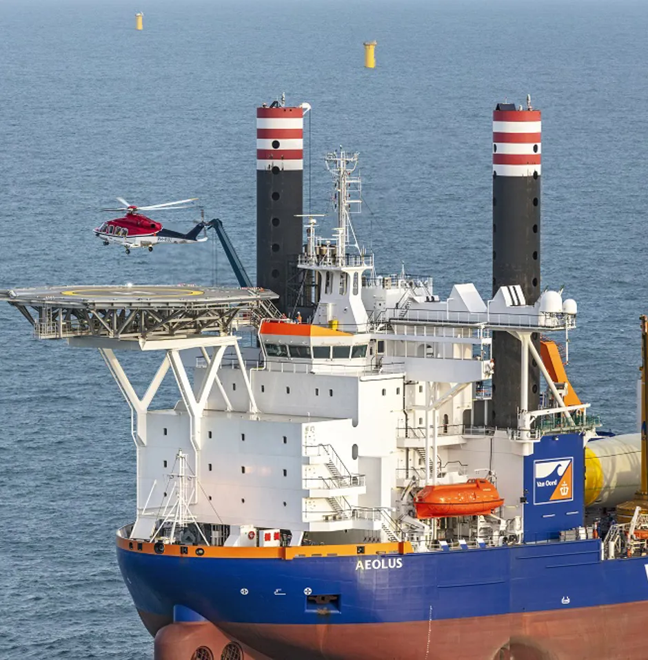 Helicopter landing on a ship at sea.