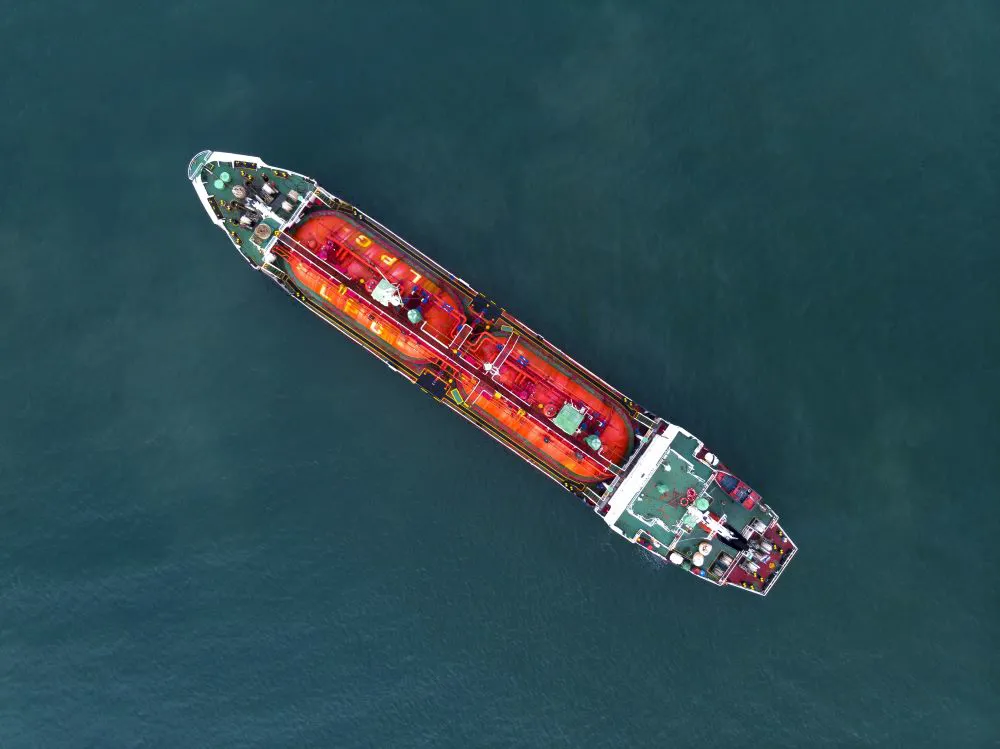 Aerial view of a large cargo ship on water.