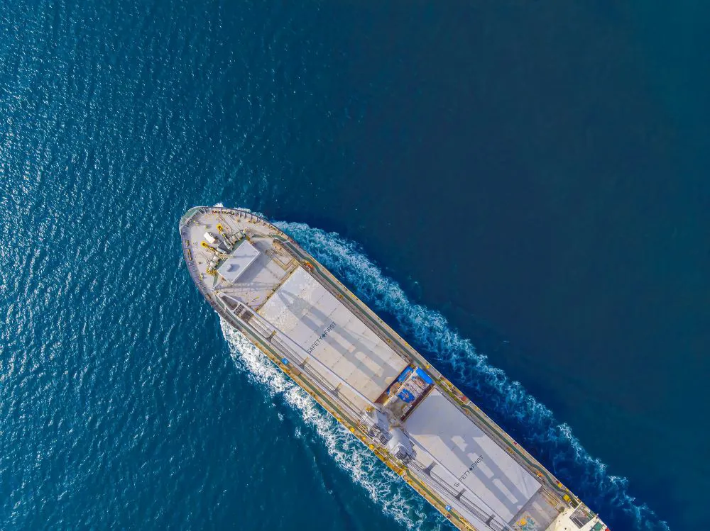 Aerial view of a cargo ship in blue water
