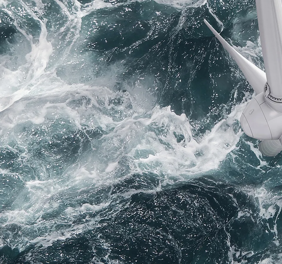 Aerial panorama of a close up wind turbine in the sea
