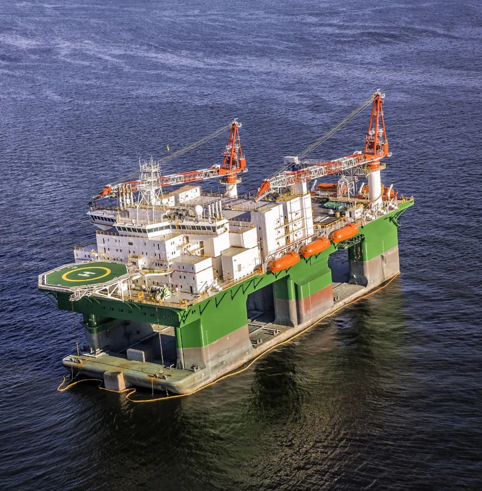 Offshore drilling rig in blue water.