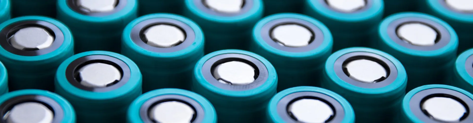 Rows of cylindrical batteries with teal casings.
