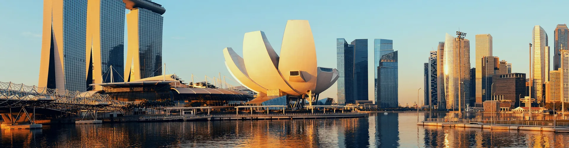 City skyline with lotus landmark reflected at sunset
