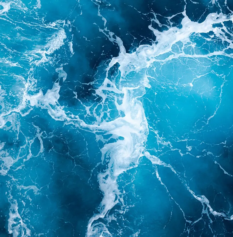 Turquoise ocean waters with white frothy waves.