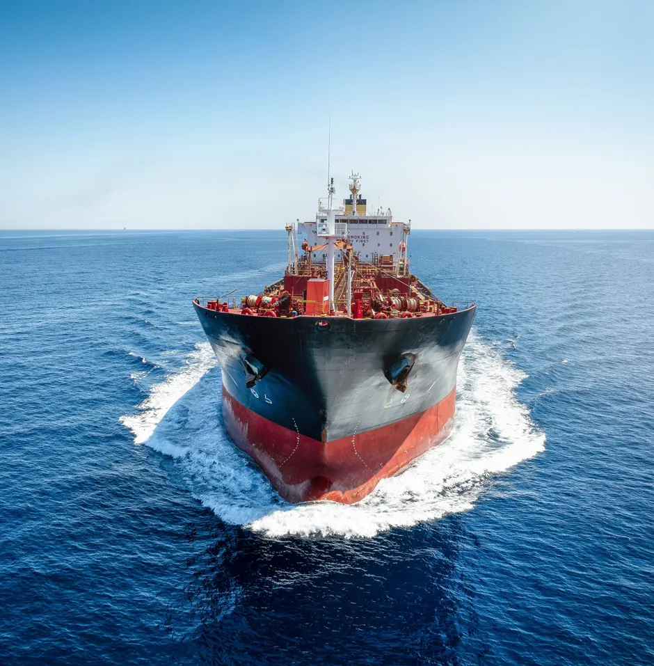 Cargo ship cutting through open ocean waves