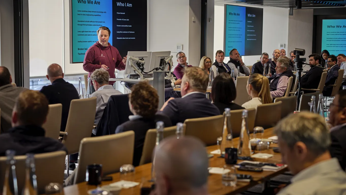 Presenter speaking to seated conference room audience