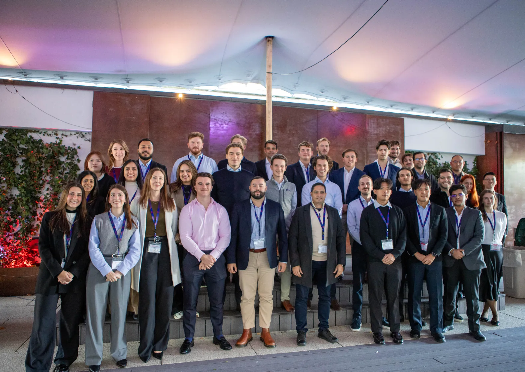 Large group posing outdoors under canopy