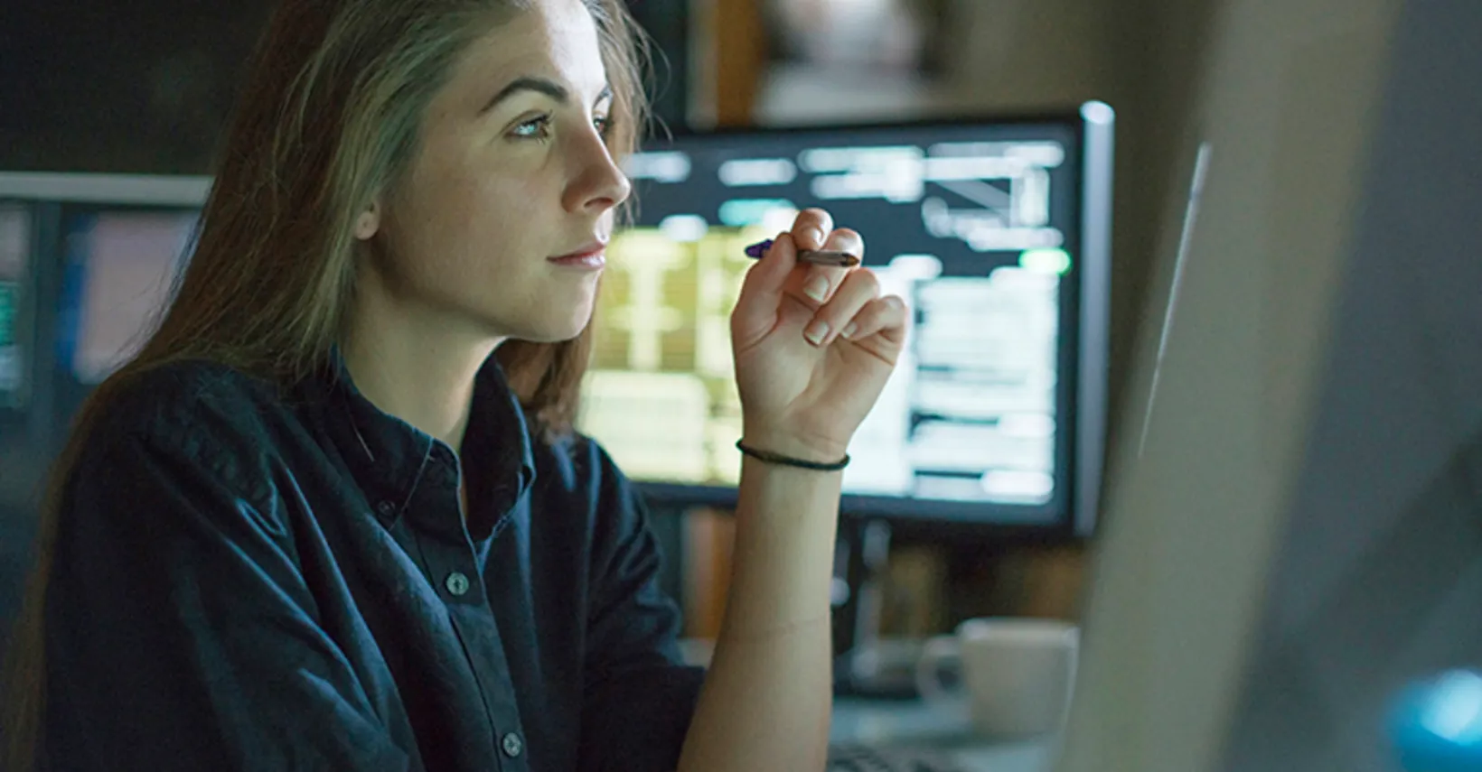 Analyst reviewing shipping market data on computer screens