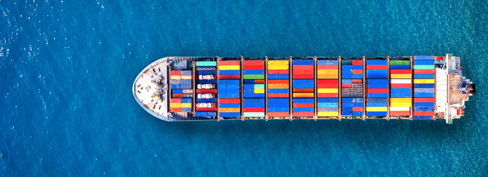 Aerial view of a laden container ship under way at sea