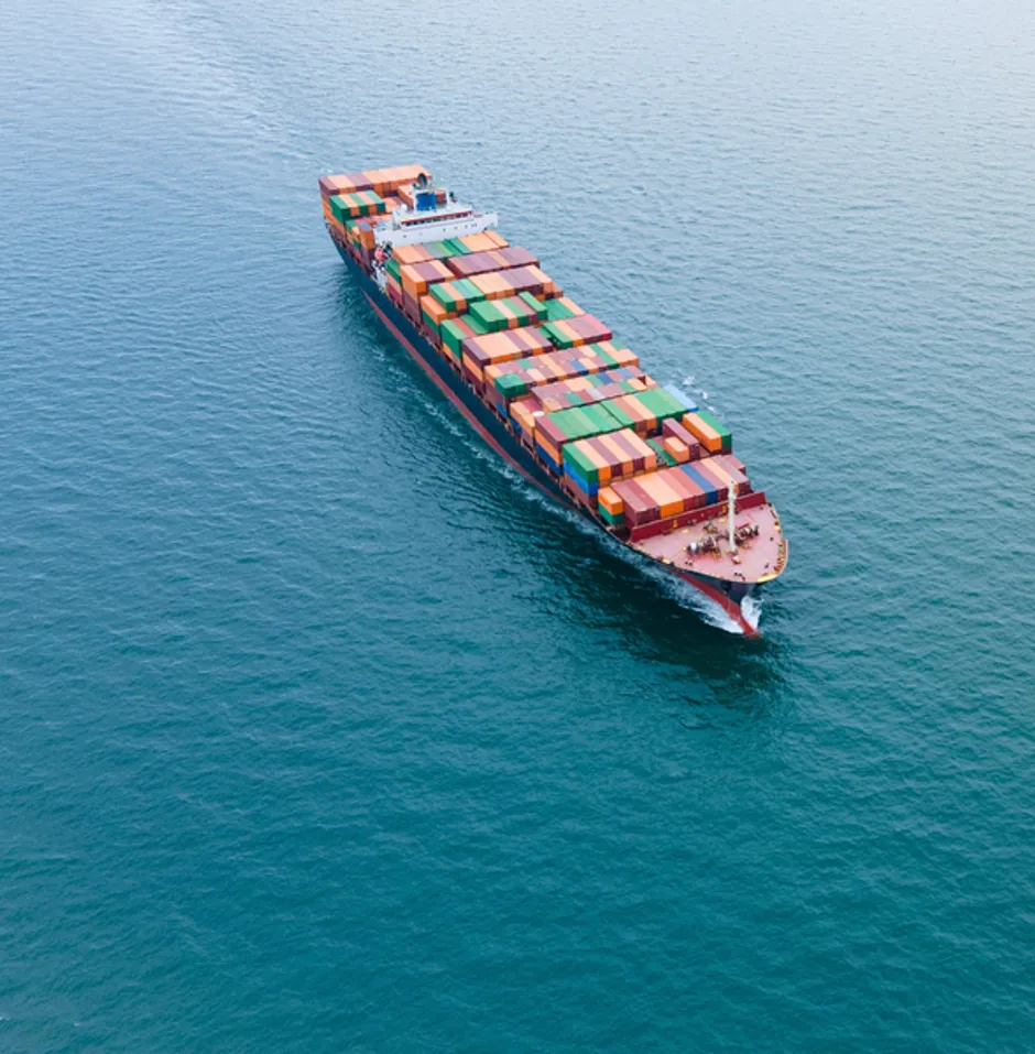 Cargo ship loaded with colourful containers, aerial view
