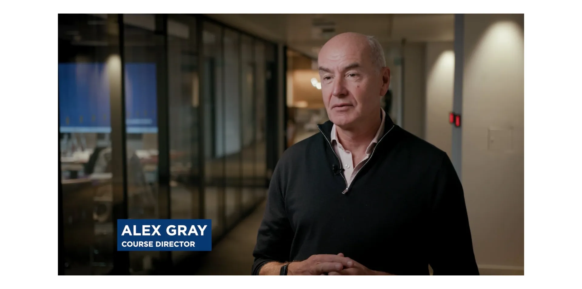 Man in black sweater, course director caption